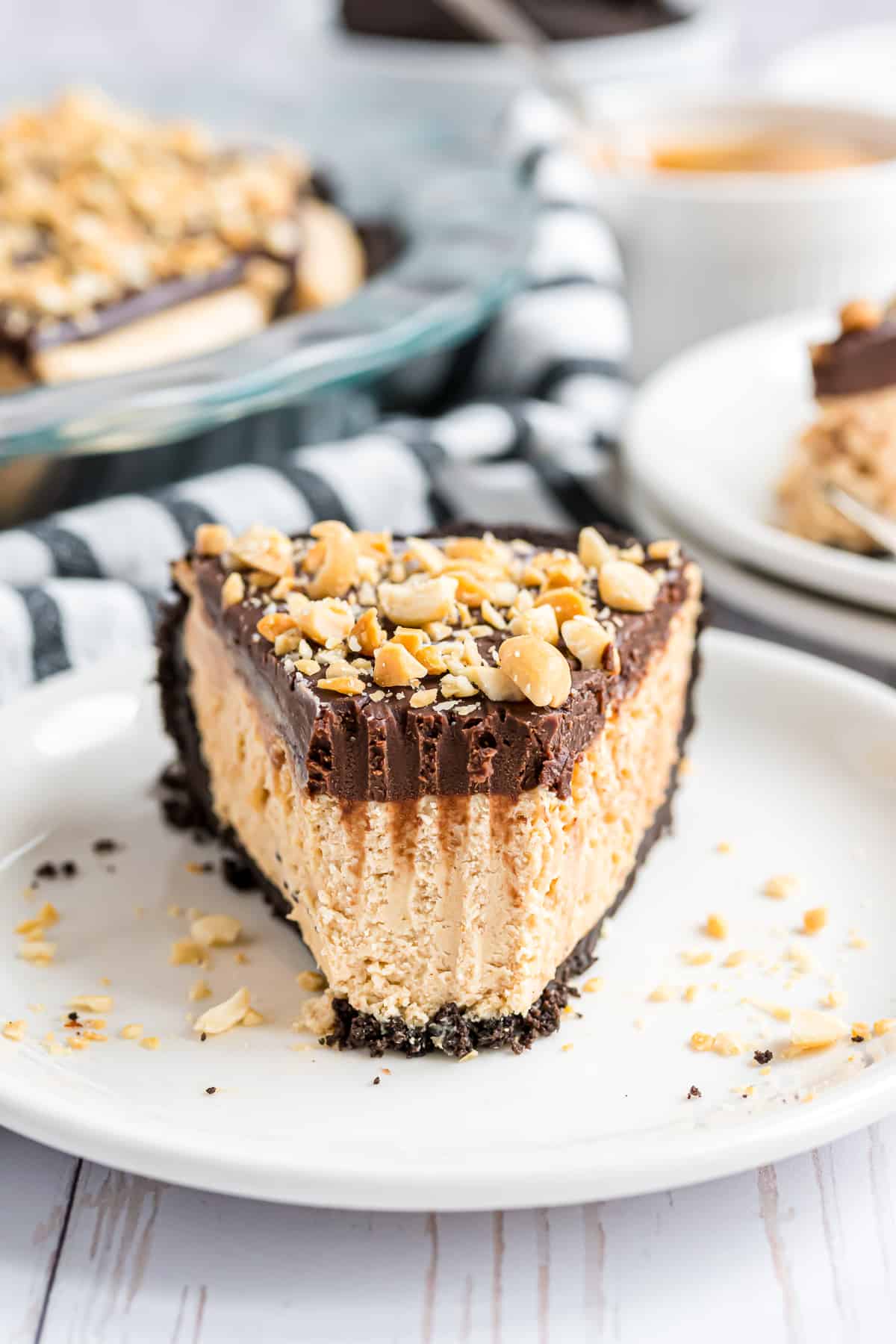 Slice of chocolate peanut butter pie with a fork mark, showing a bite removed.