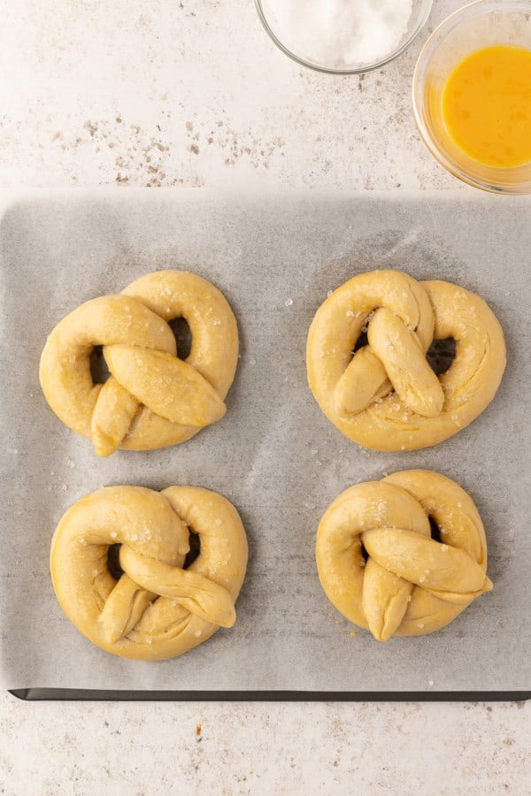 Unbaked pretzels sprinkled with salt.