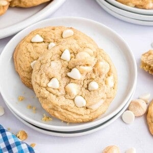 White chocolate macadamia nut cookies on a white plate.