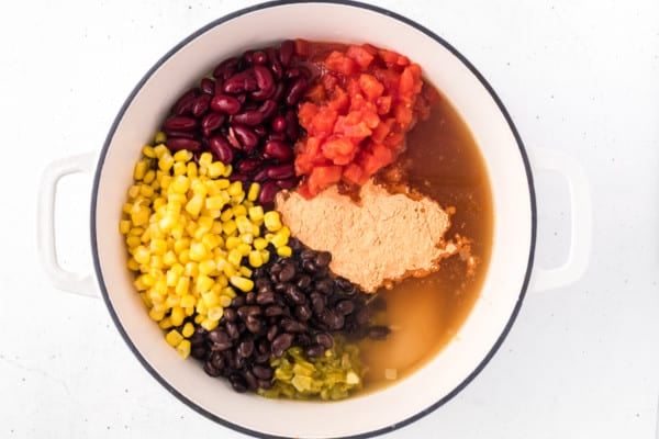 Ingredients for chicken taco soup combined in a large pot.