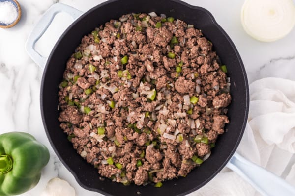 Overhead view of browned ground beef in a skillet.