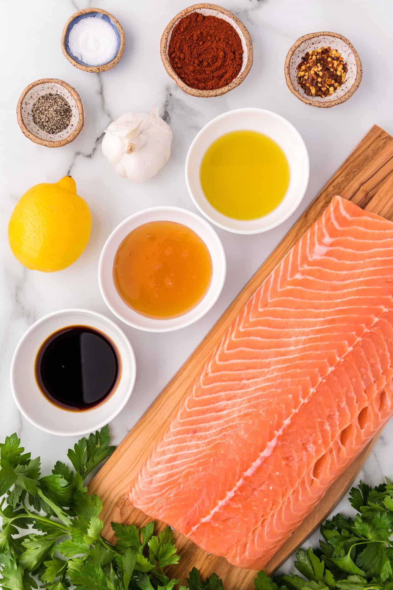 Ingredients needed for honey garlic salmon, including a large filet of salmon.