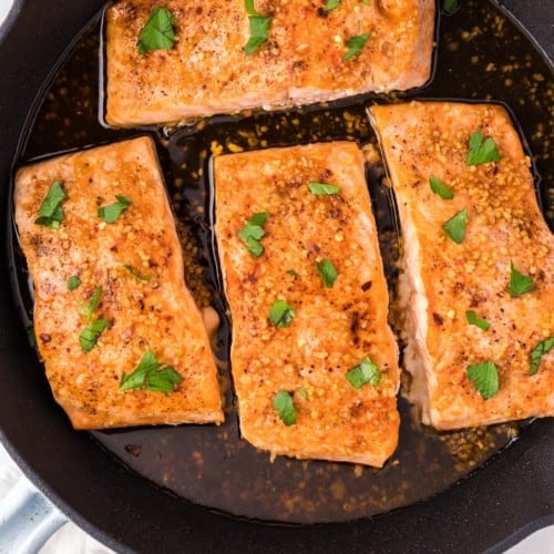 Honey garlic salmon topped with fresh parsley.