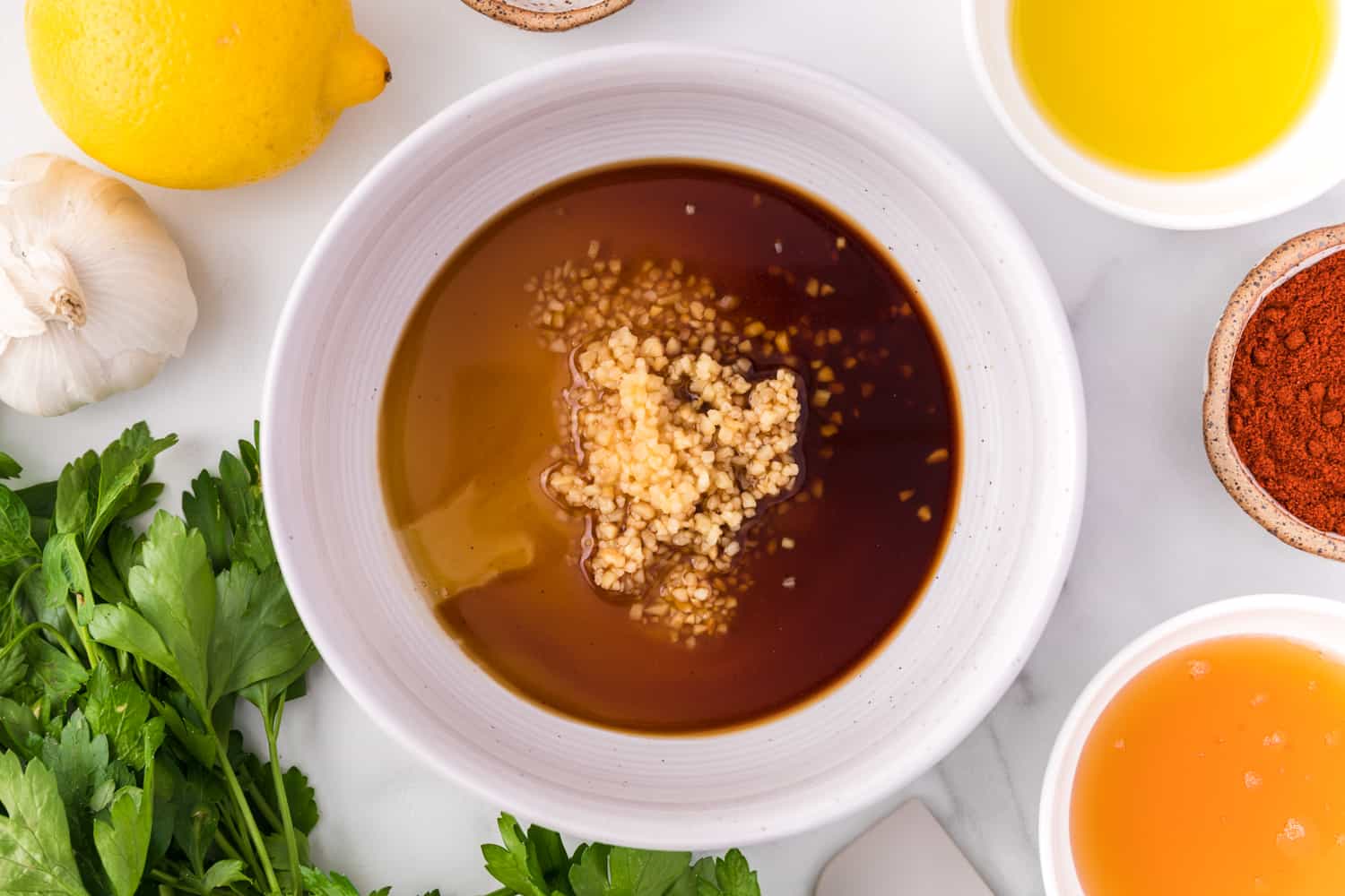 Honey garlic glaze in a small white bowl.