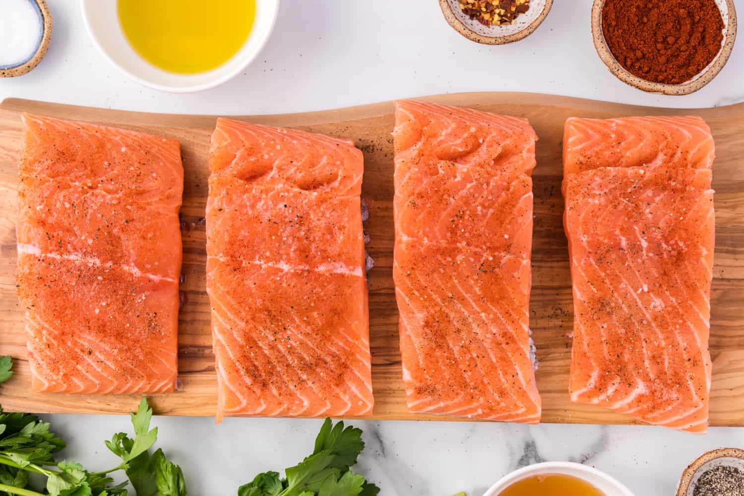 Salmon fillets seasoned with salt and pepper.