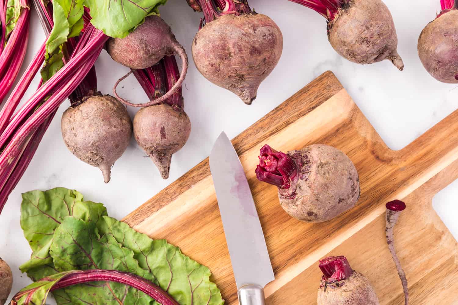 Greens being trimmed from beets.