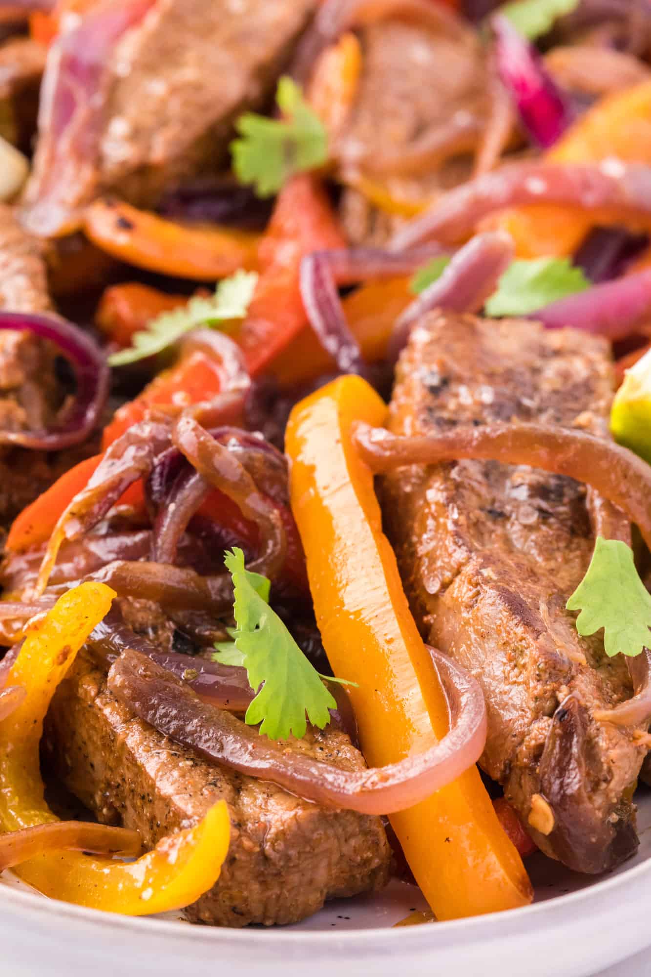 Close up of steak fajitas garnished with cilantro.