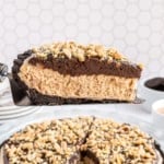 Slice of chocolate peanut butter pie being lifted from the rest of the pie.