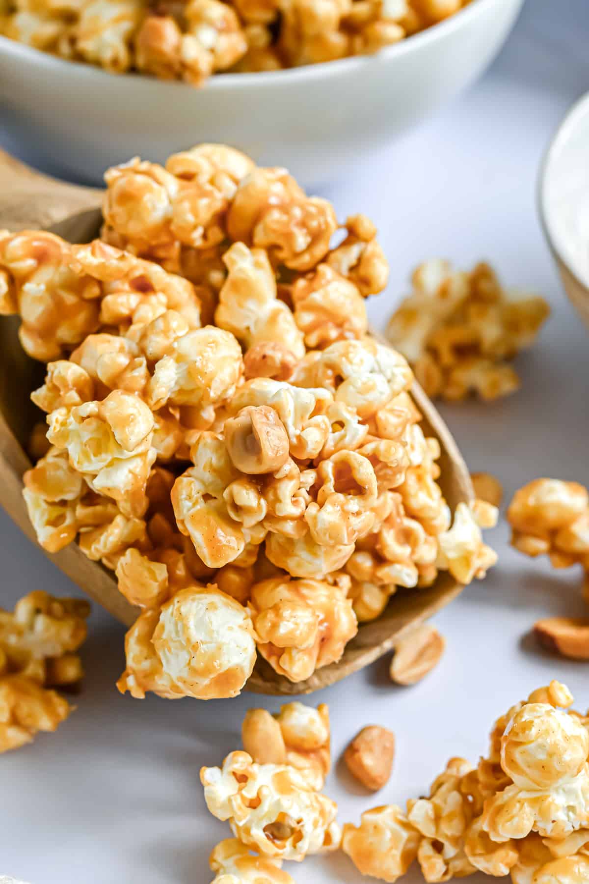 Peanut butter popcorn on a large wooden spoon.