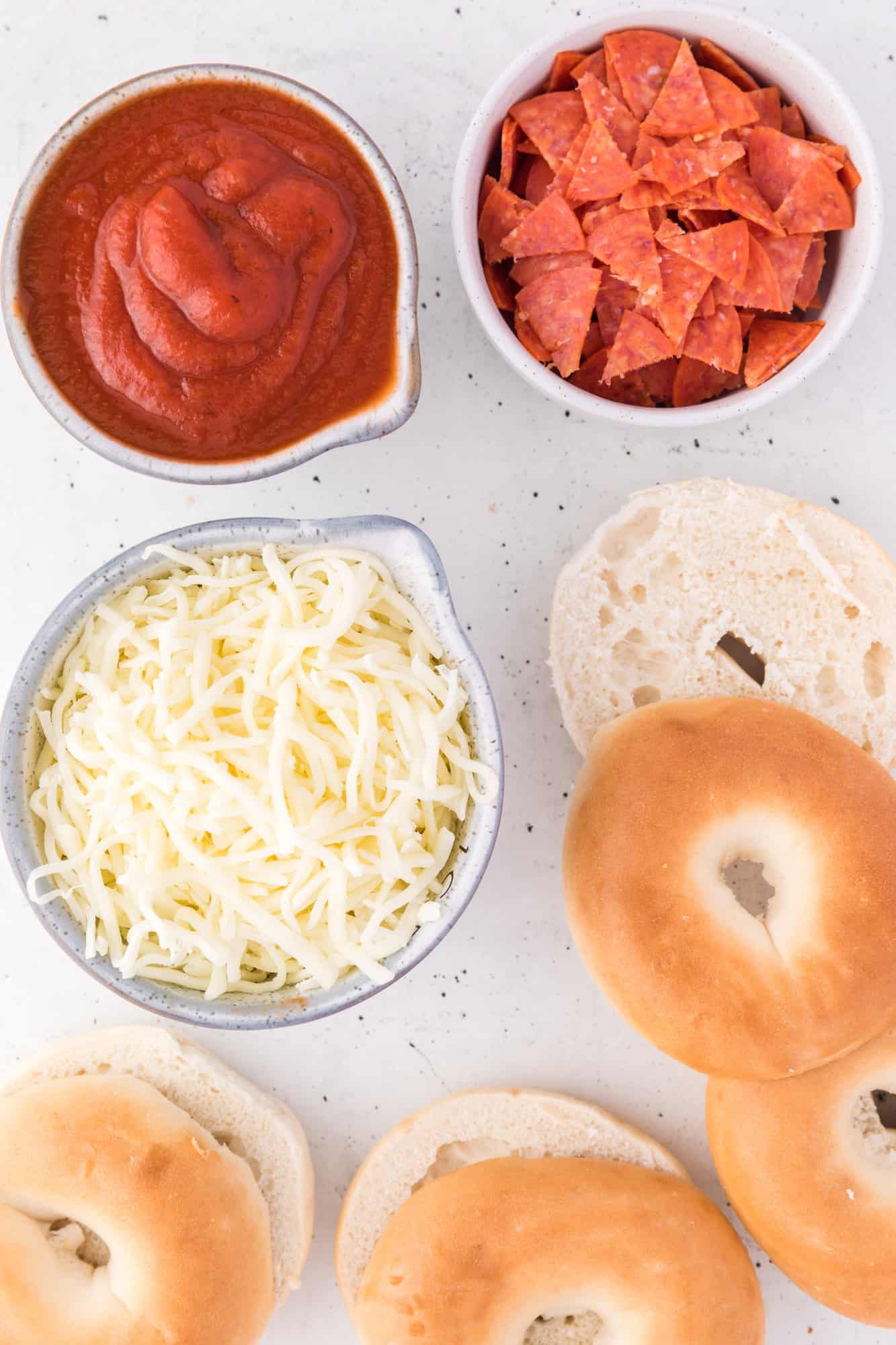 Overhead view of ingredients needed for bagel bite pizzas.