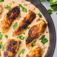 Overhead view of cream of mushroom chicken in a skillet garnished with parsley.