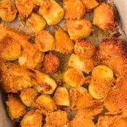 Overhead view of parmesan potatoes in a baking dish.