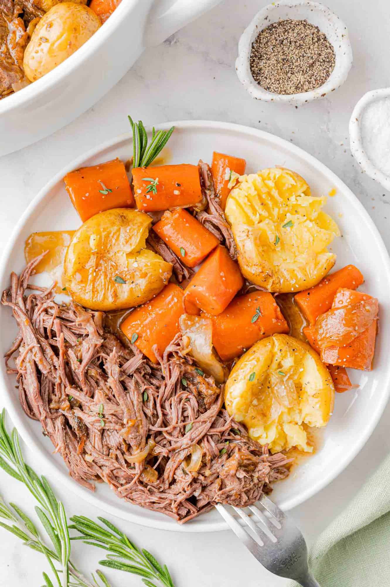 Plated pot roast with potatoes and carrots.
