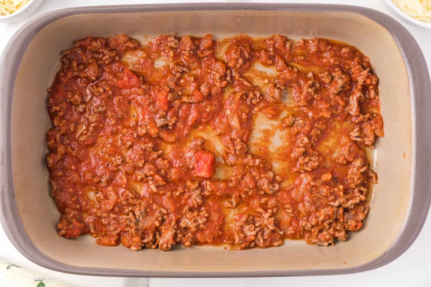 Meat sauce in the bottom of the pan.