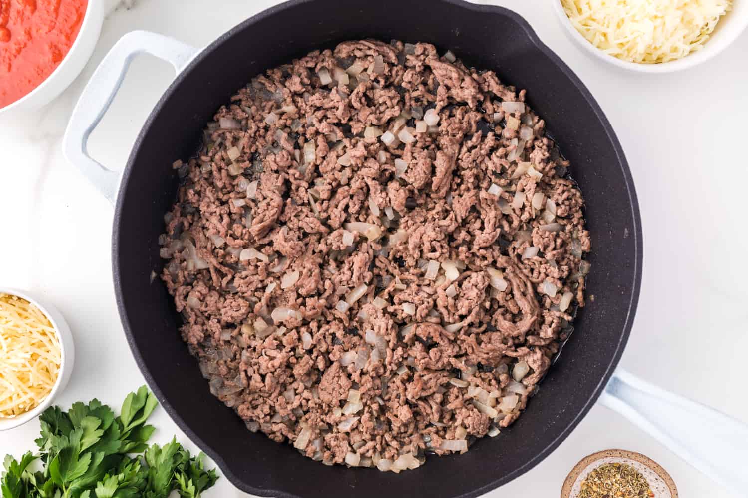 Ground beef in a black skillet.