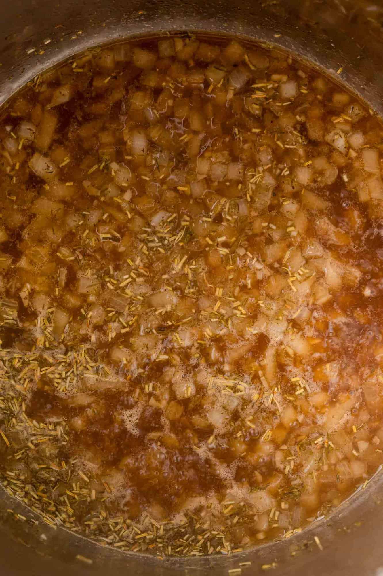 Herbs added to onions and broth.