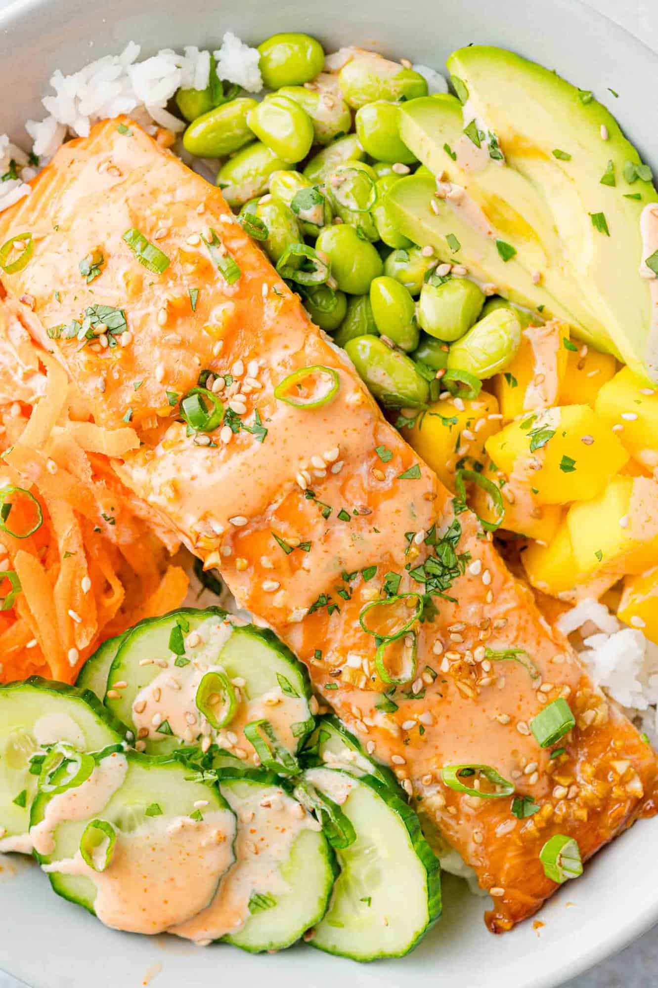 Close up view of salmon bowl with lots of toppings.