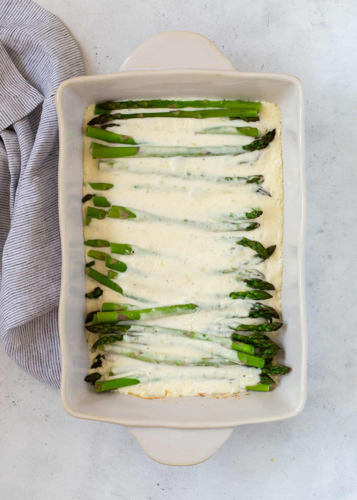 Cheese sauce added to asparagus.