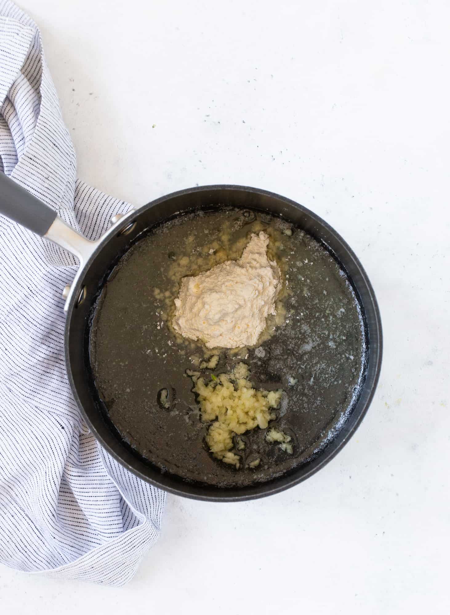 Flour and garlic added to melted butter.