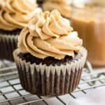 Peanut butter frosting piped on a chocolate cupcake.