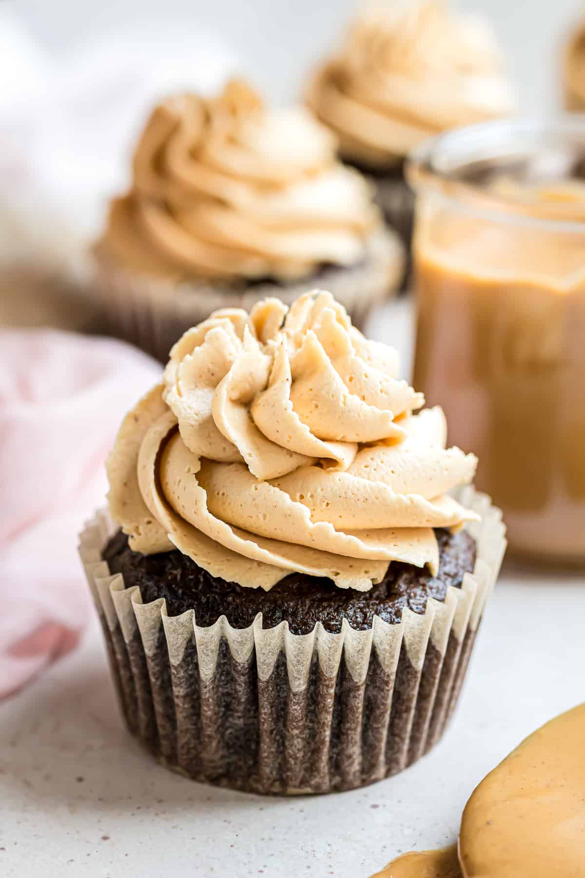 Peanut butter frosting piped on a chocolate cupcake.