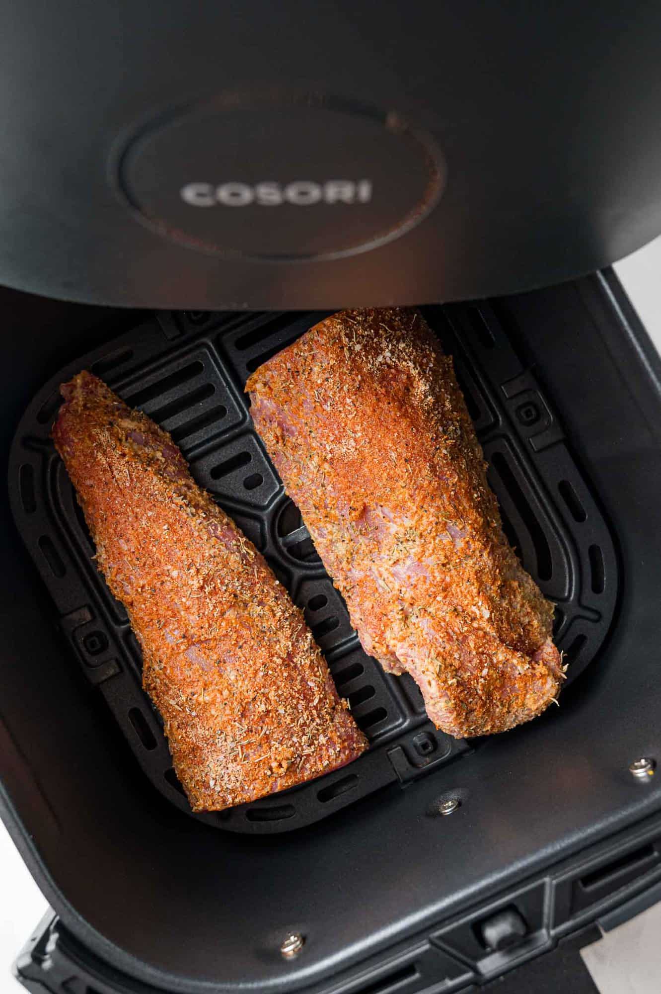 Uncooked pork tenderloin in air fryer. 