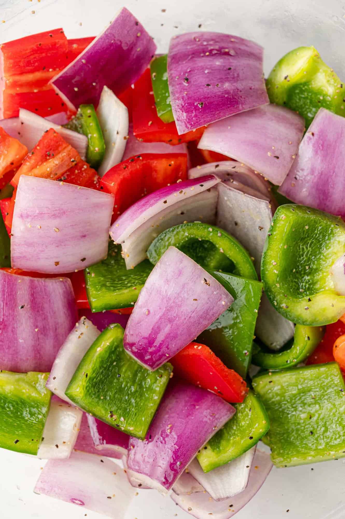 Peppers and onions mixed with oil and seasonings.