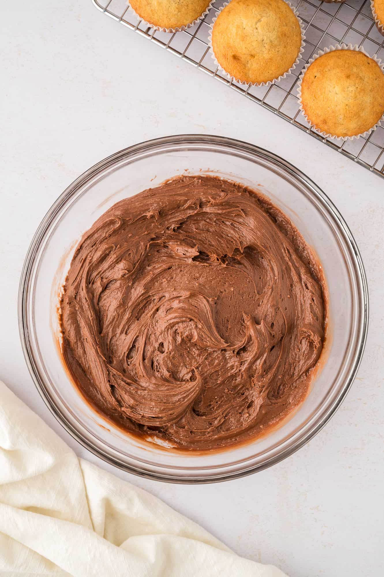 Completed frosting in a clear glass bowl.