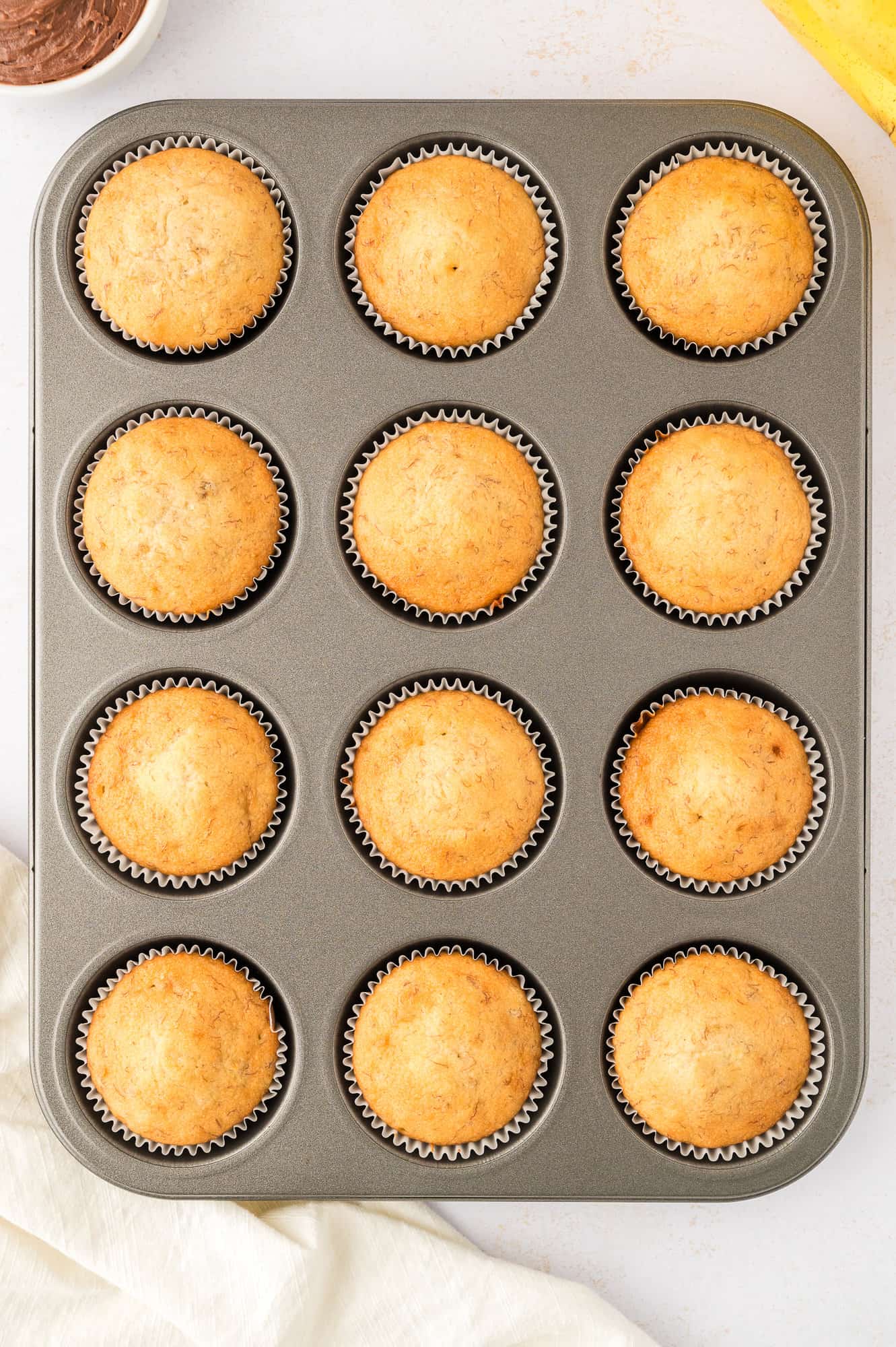 Baked cupcakes, still in tin.