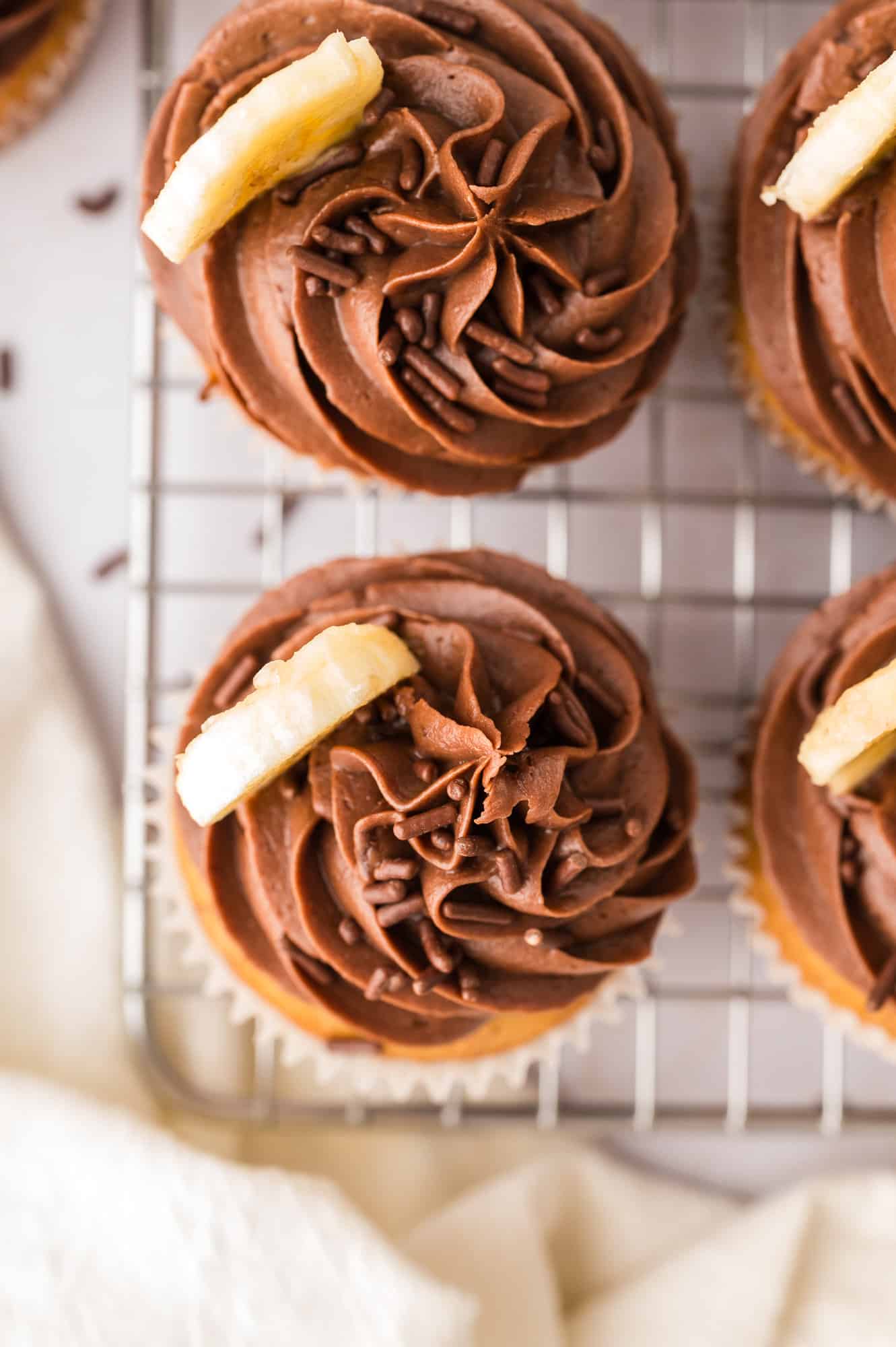 Overhead view of cupcakes with piped on chocolate frosting.