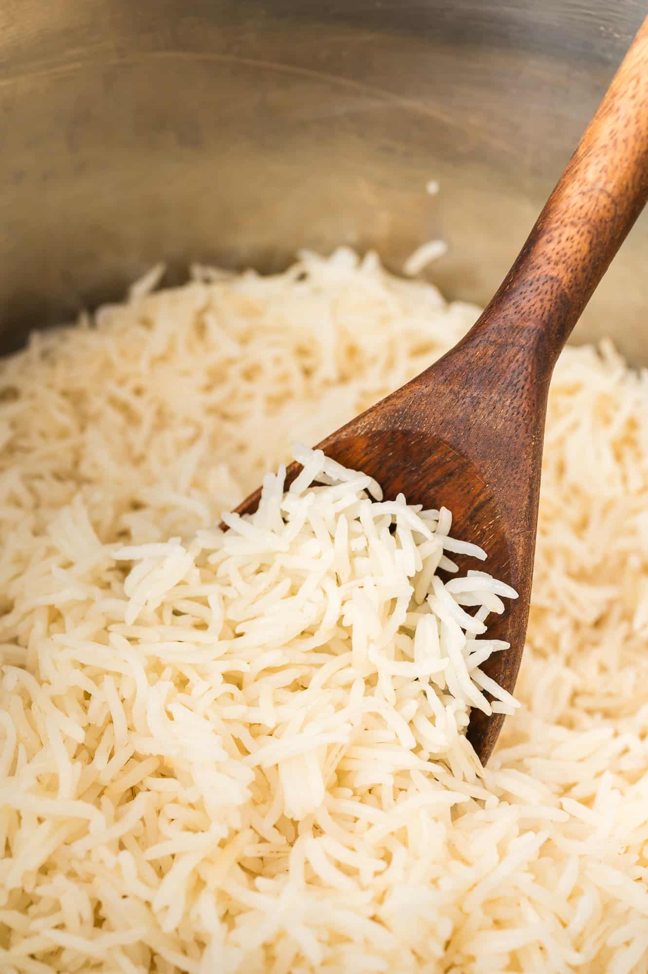 Instant pot basmati rice, still in the Instant Pot and on a wooden spoon.