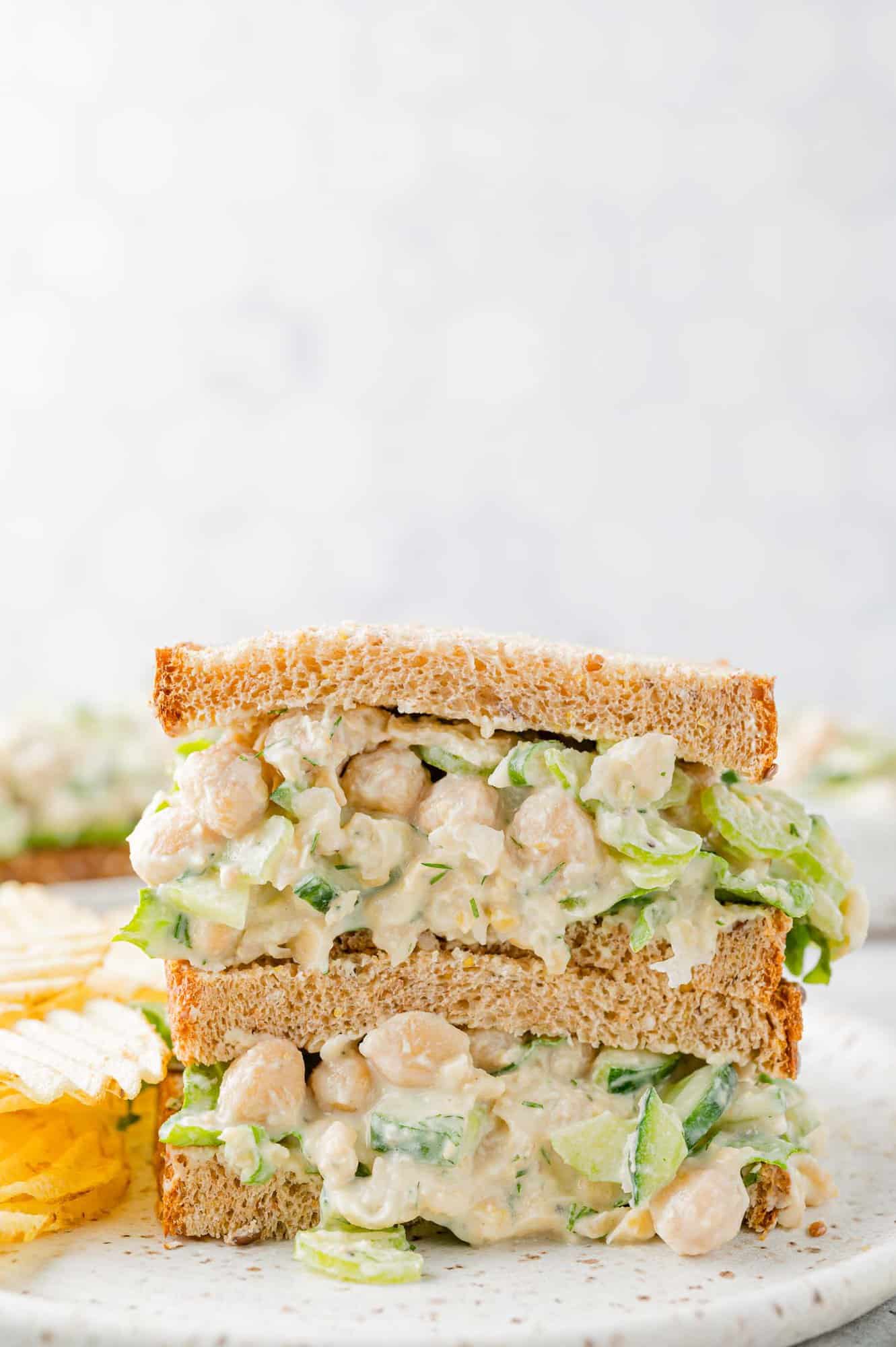 Two halves of a chickpea salad sandwich, stacked up.