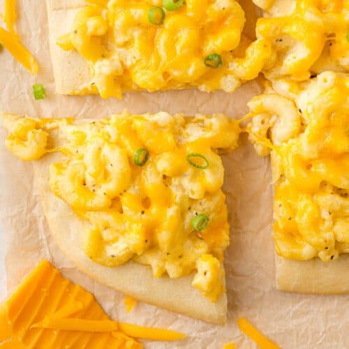 Mac and cheese pizza cut into squares.