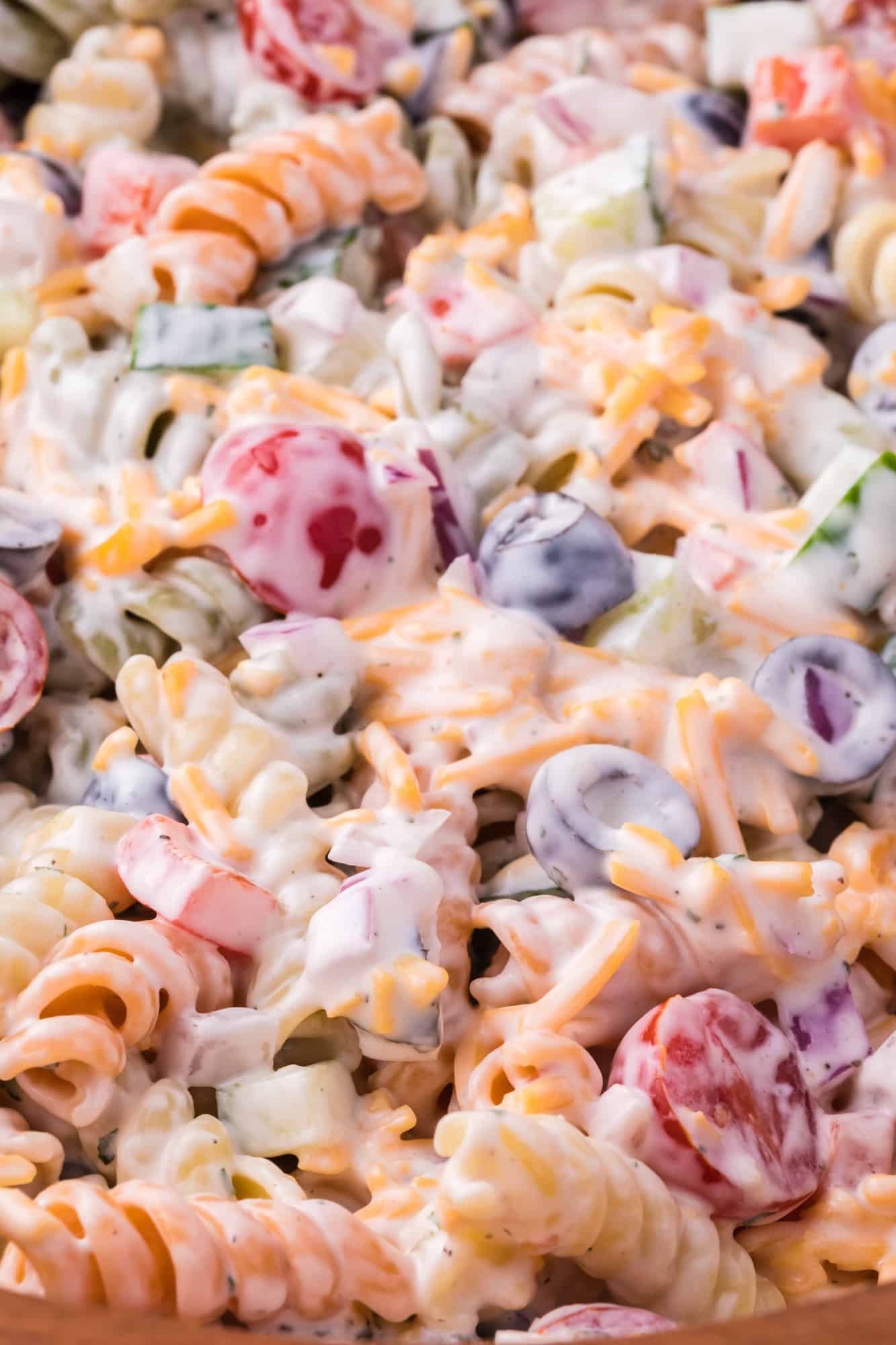 Ranch pasta salad, close up, showing ingredients coated in dressing.