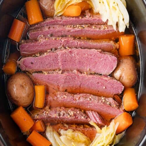 Slow cooker corned beef with carrots, potatoes, cabbage.