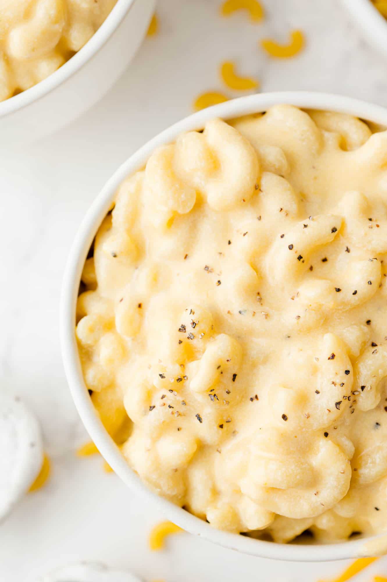 Creamy light yellow stovetop macaroni and cheese in a white bowl.