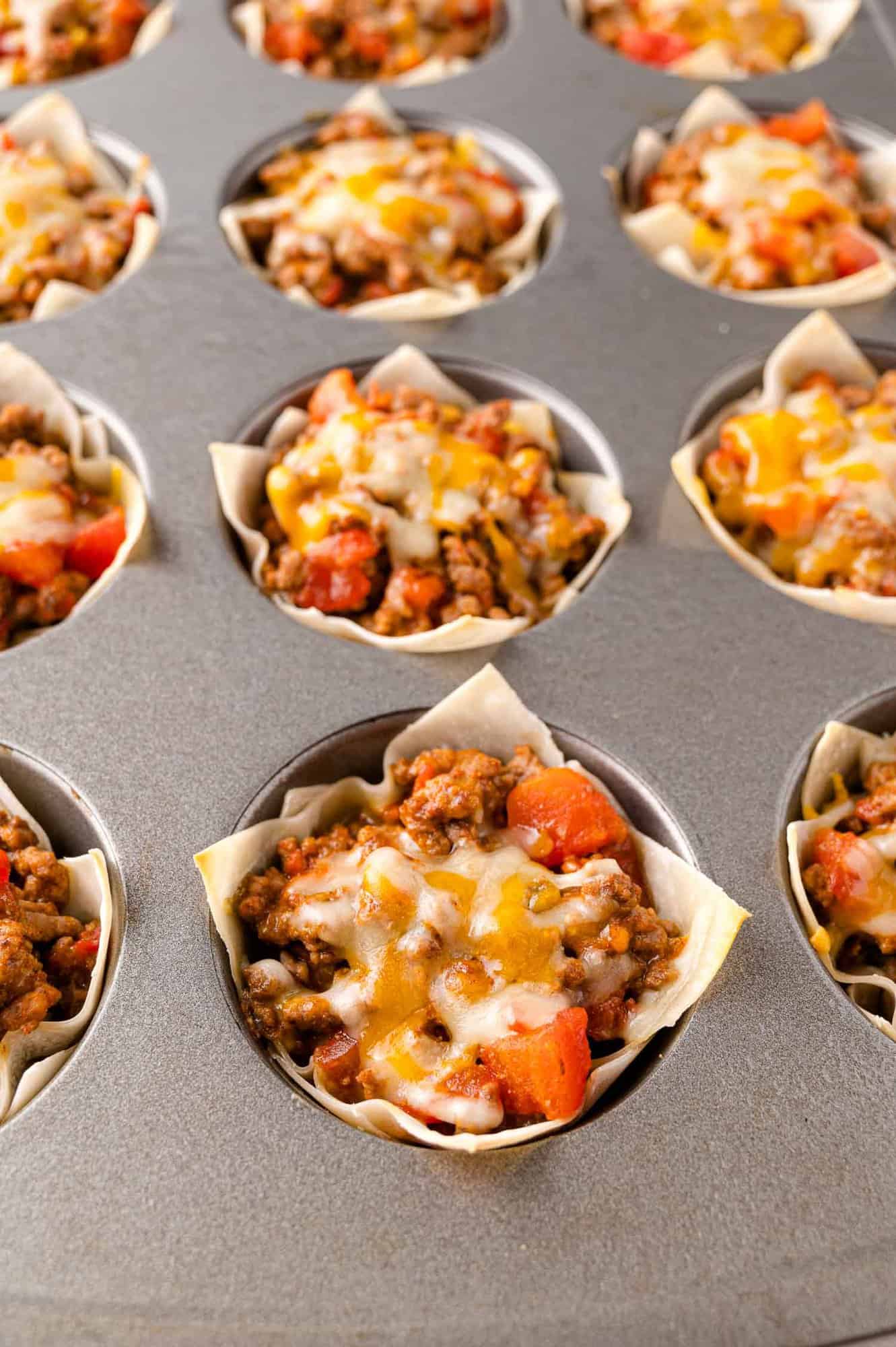 Cooked taco cups still in muffin tin.