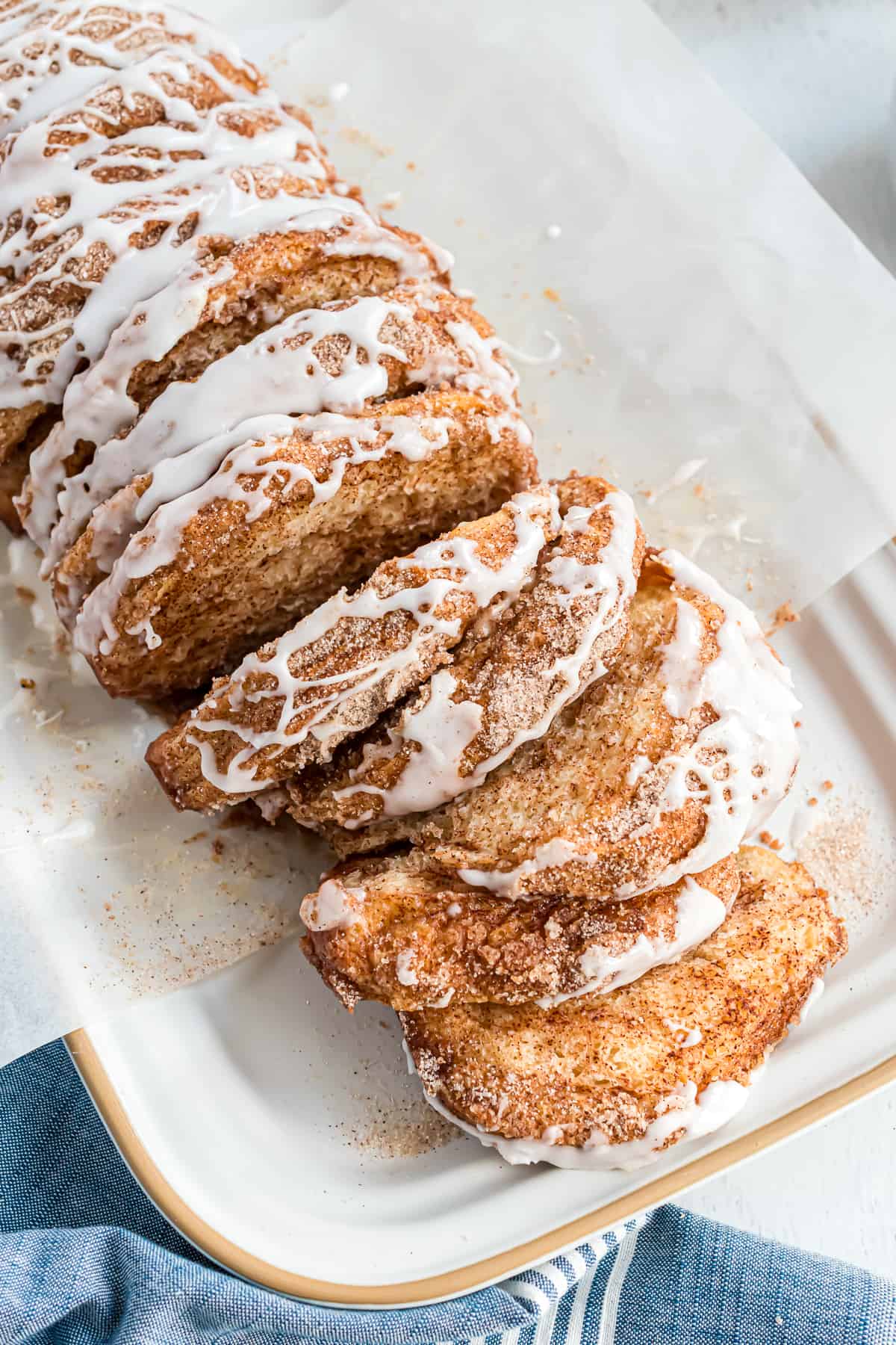 Loaf of cinnamon sugar pull apart bread, partially pulled apart.