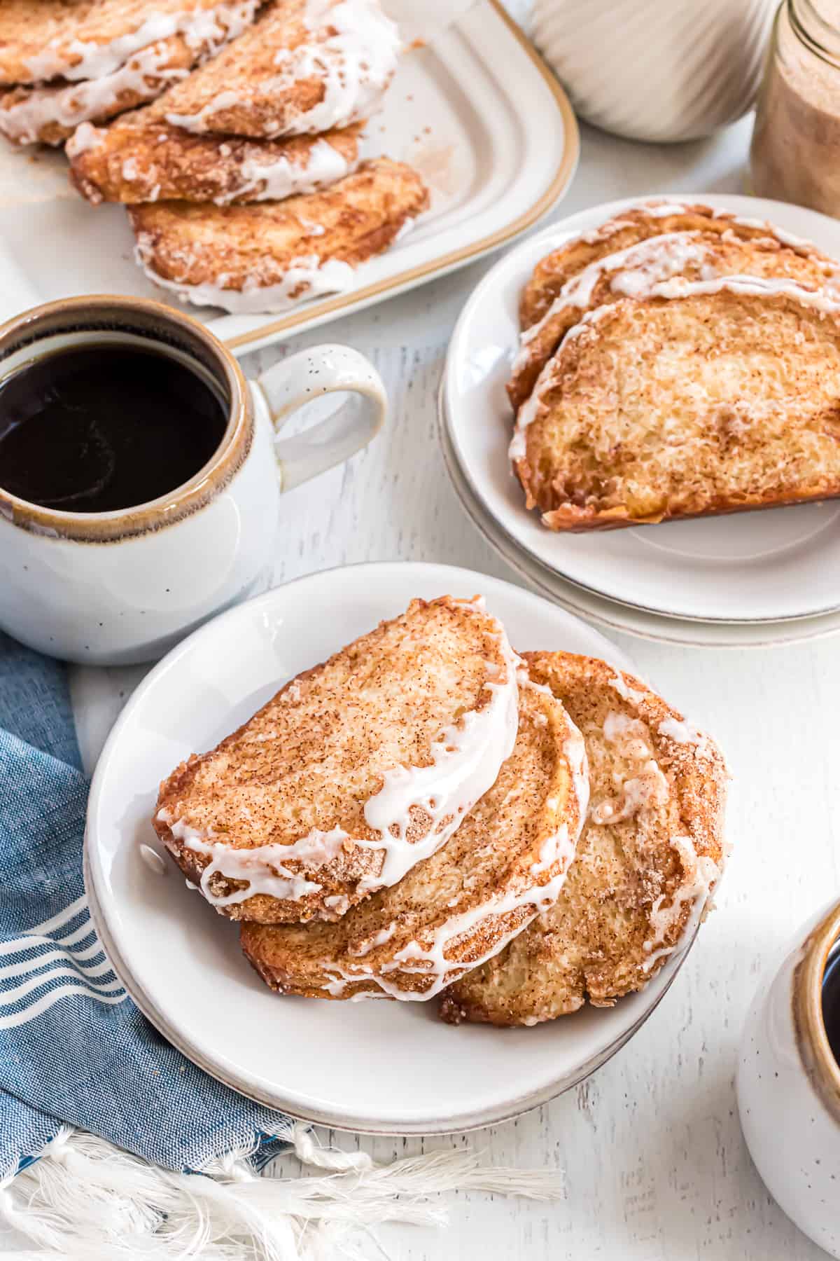 Slices of pull apart bread placed on small white plates.