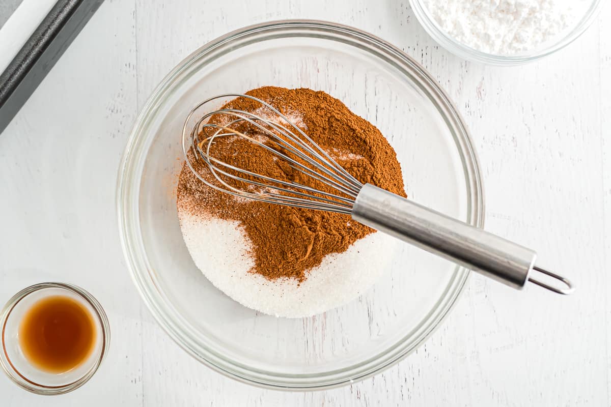 Cinnamon and sugar in a bowl, not yet mixed.