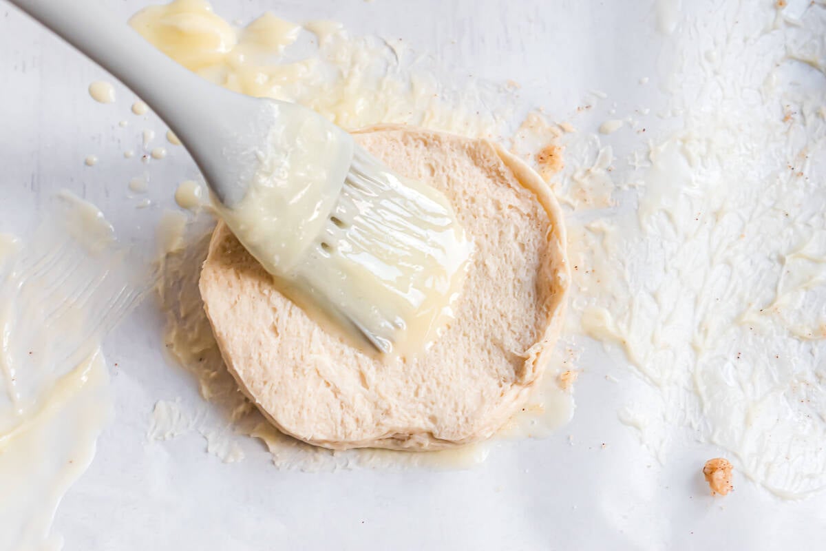 Biscuit being brushed with butter.