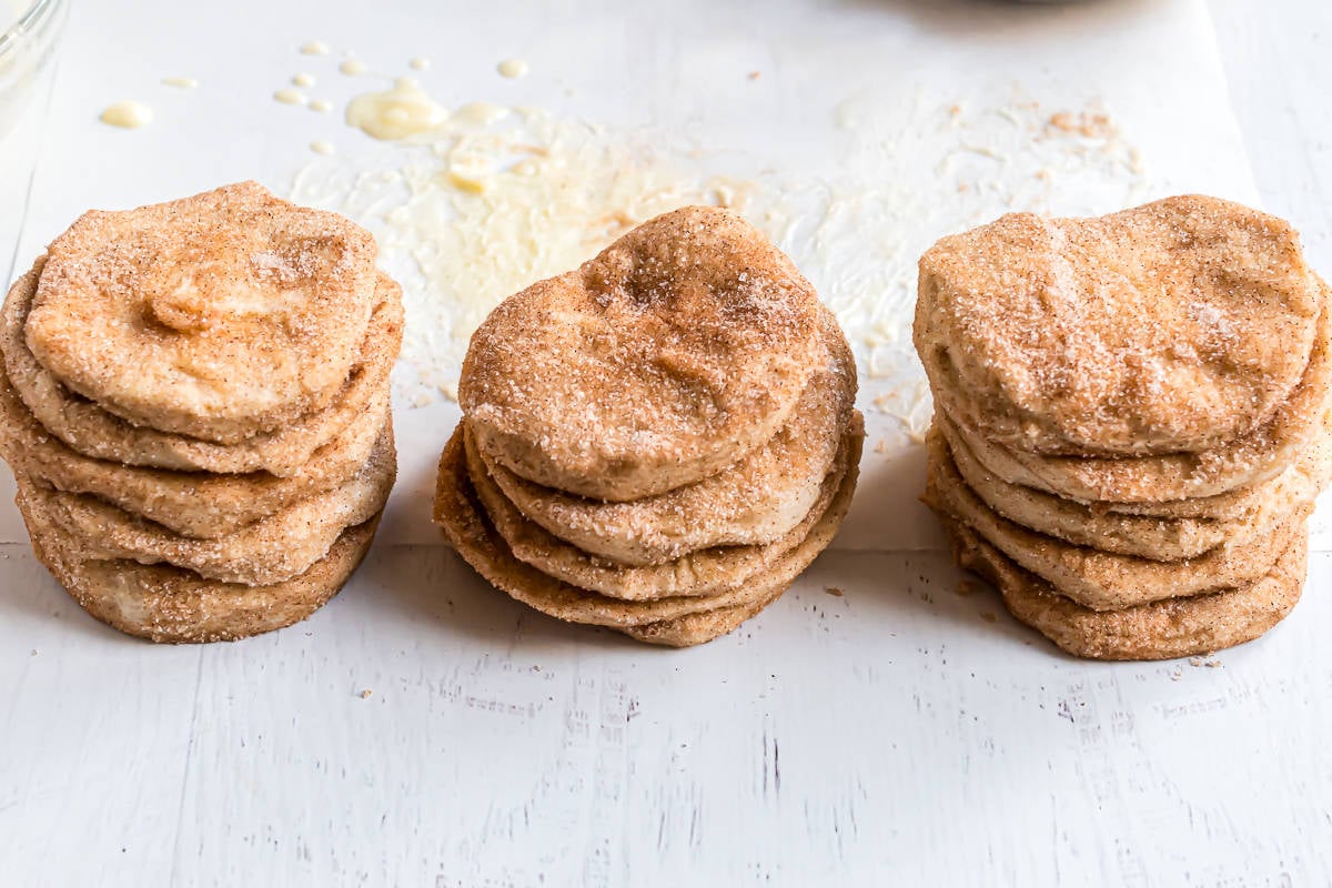 Cinnamon sugar biscuit pieces stacked in piles.