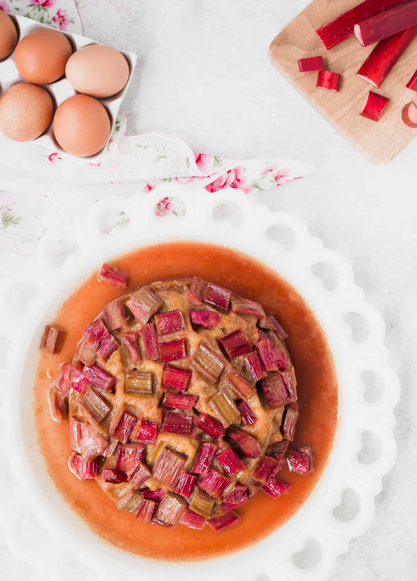 Overhead view of cake flecked with rhubarb pieces.