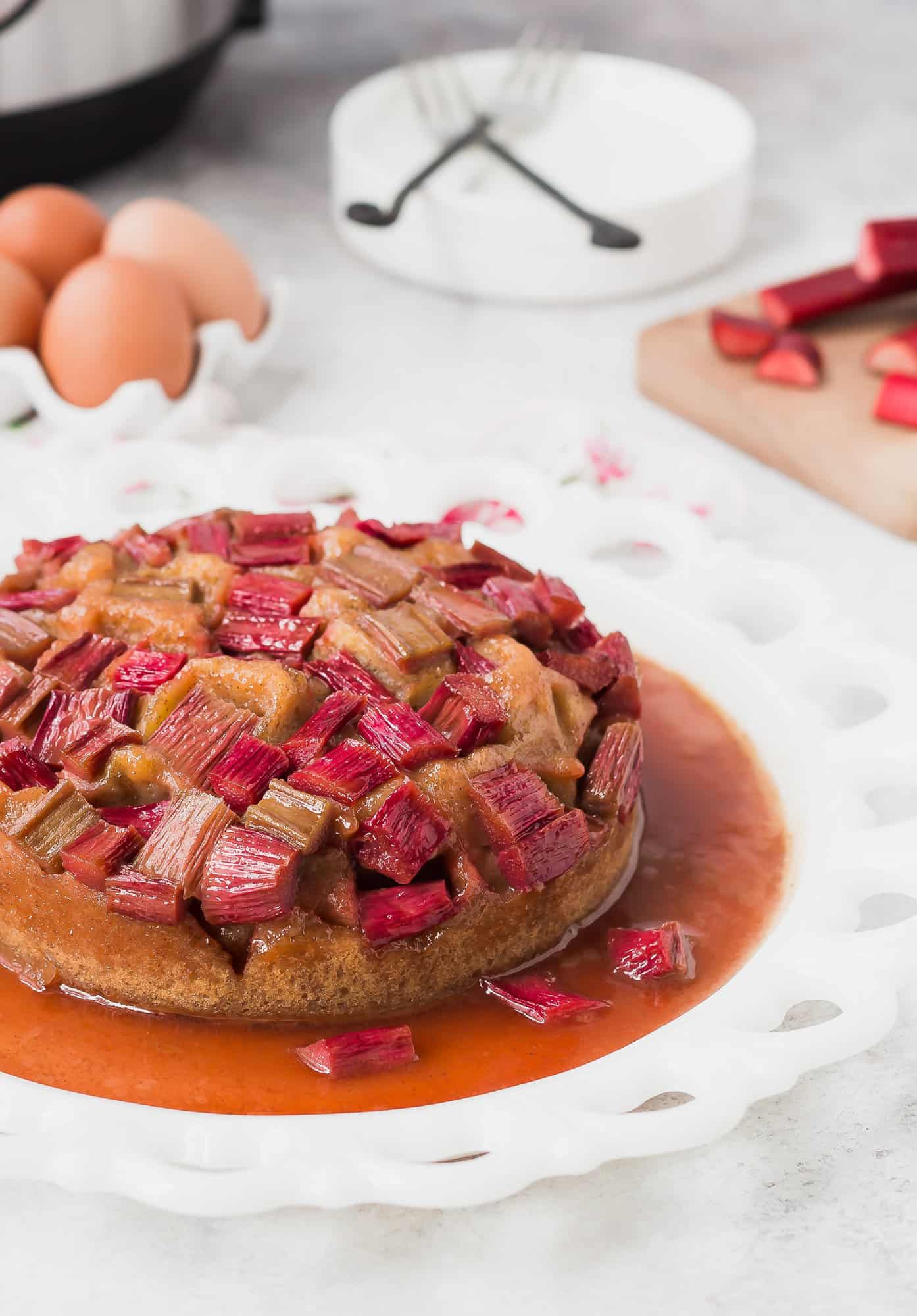 Rhubarb cake in front of eggs, rhubarb, and an Instant Pot.