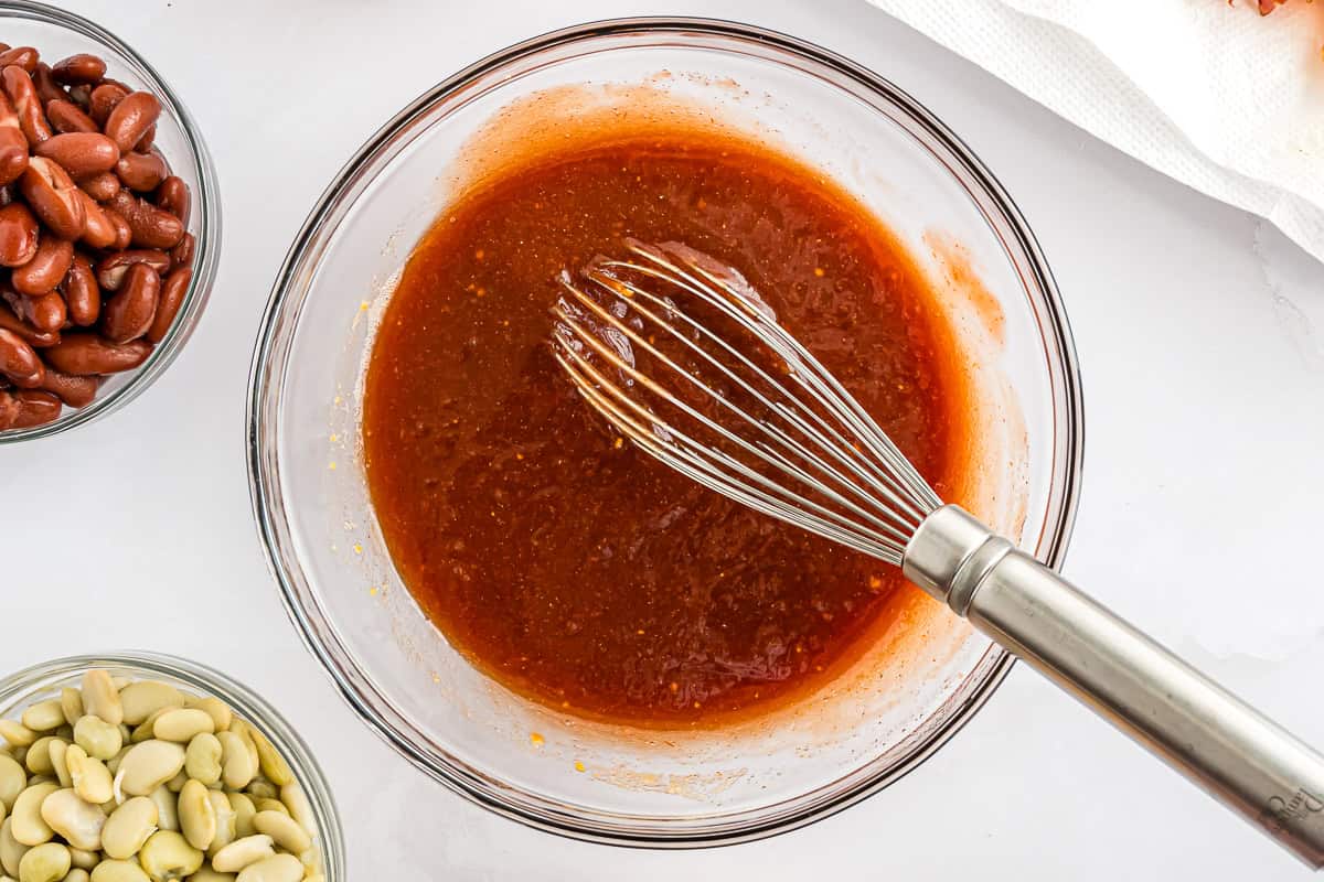 Sauce ingredients mixed together with a whisk.
