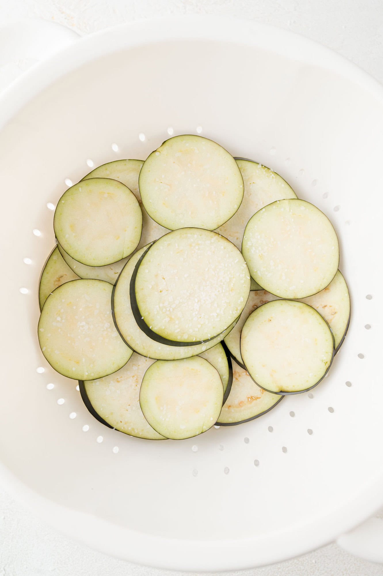 Eggplant slices sprinkled with salt.