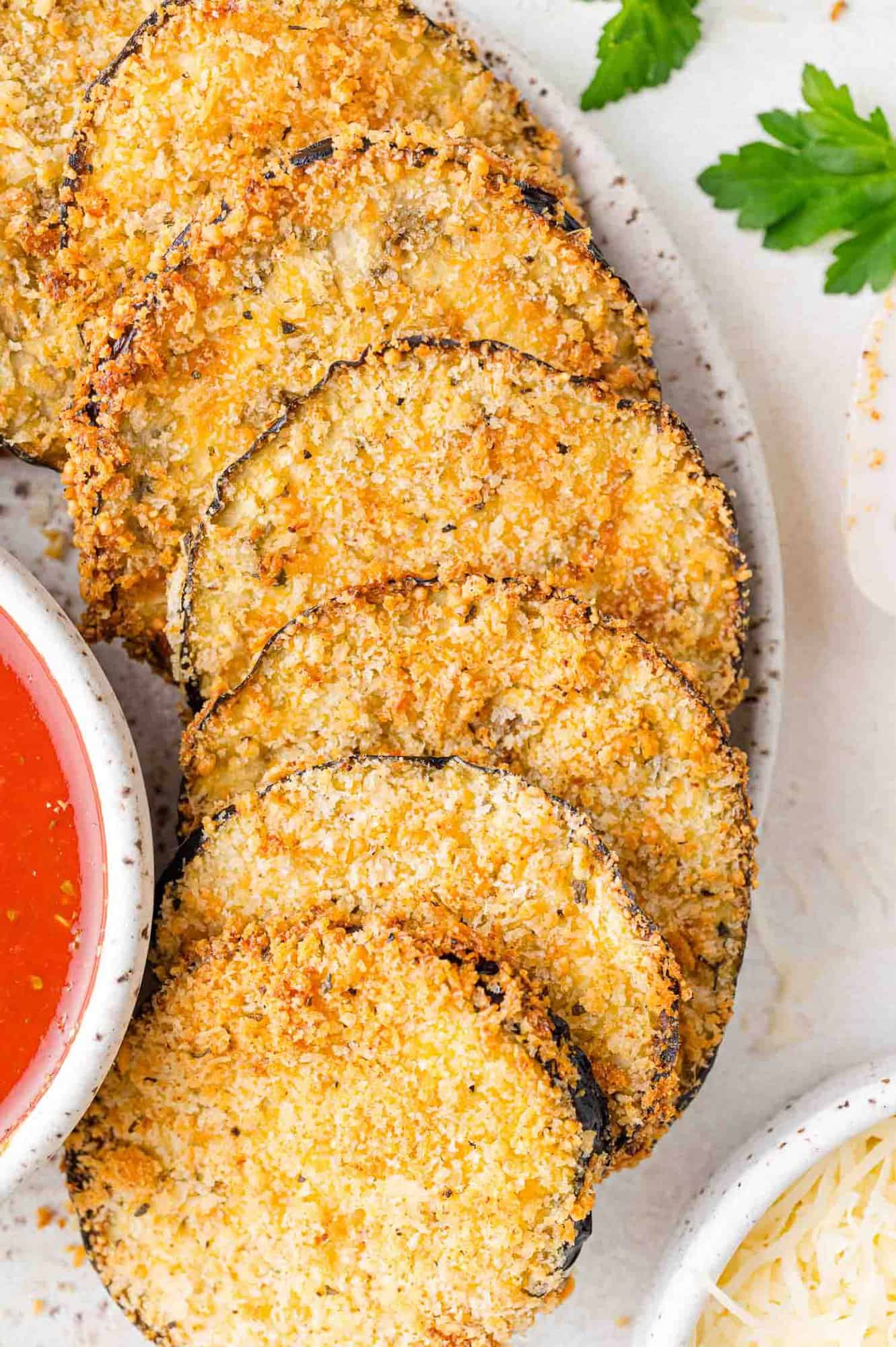 Air fryer eggplant slices, arranged on a plate.
