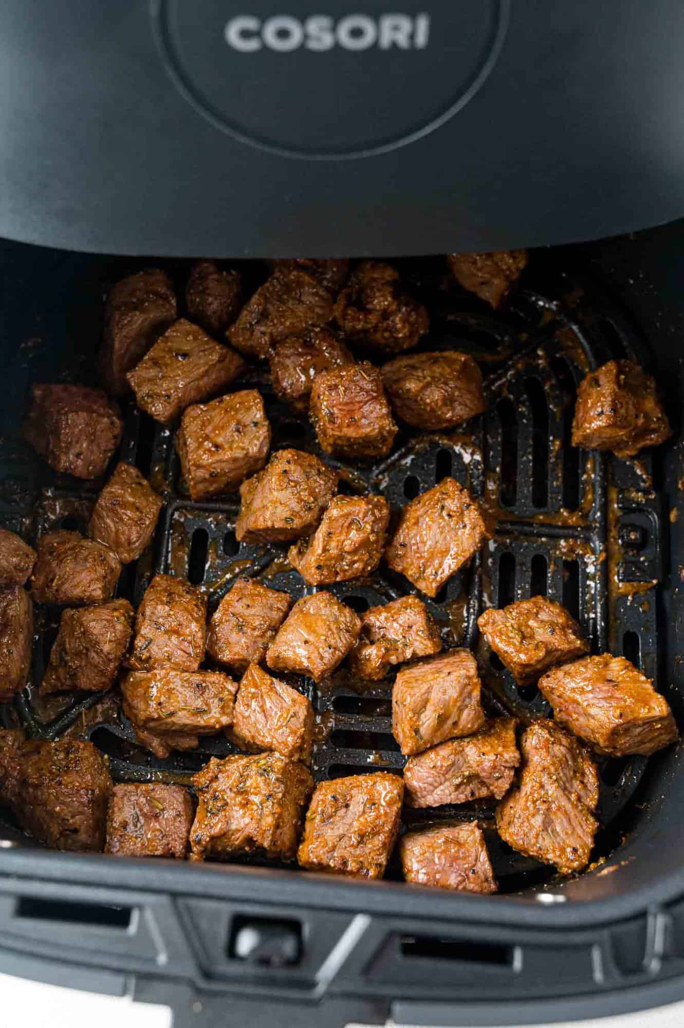 Seasoned cooked steak bites, still in air fryer.