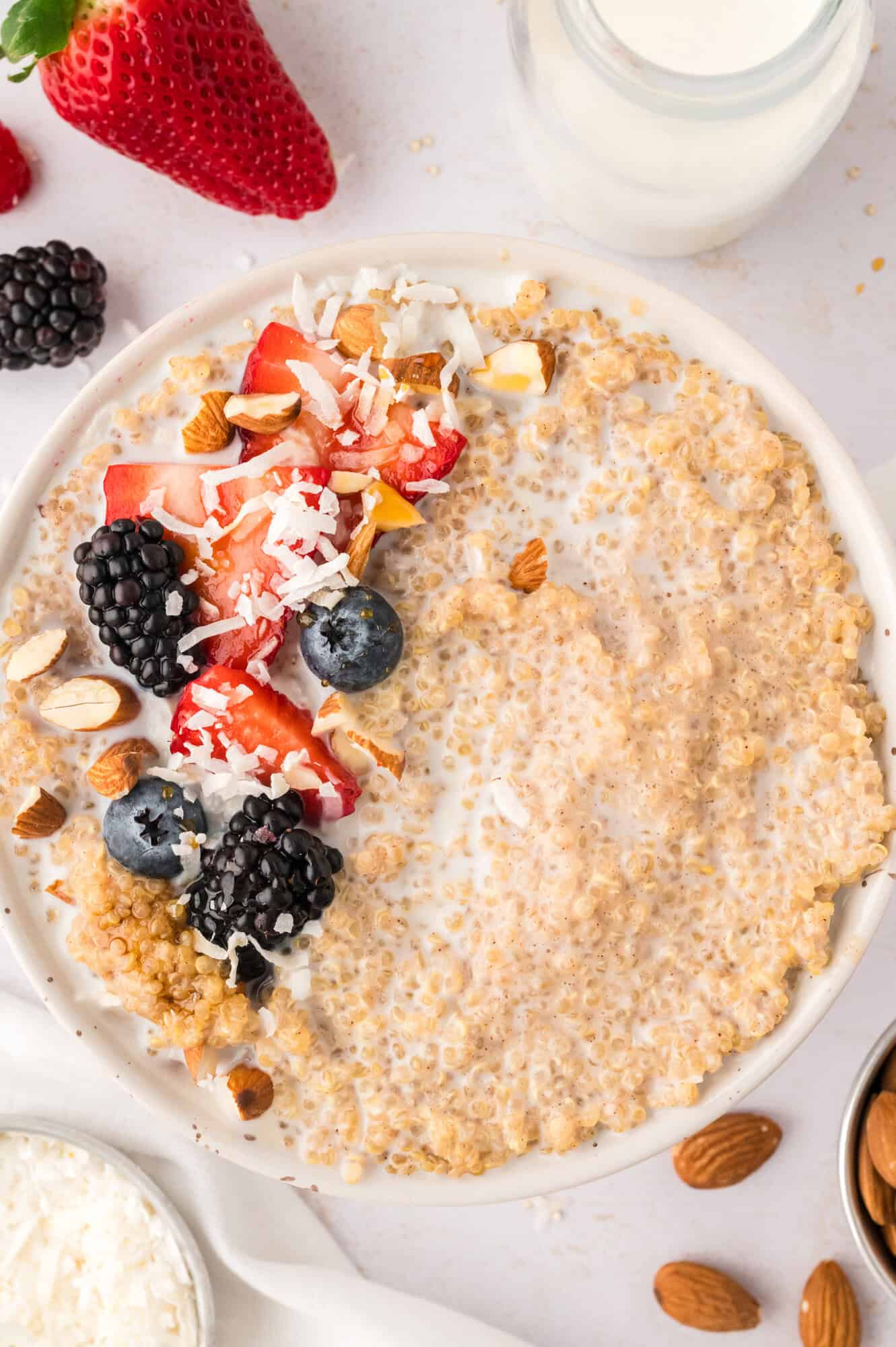 Breakfast quinoa topped with berries and coconut flakes.