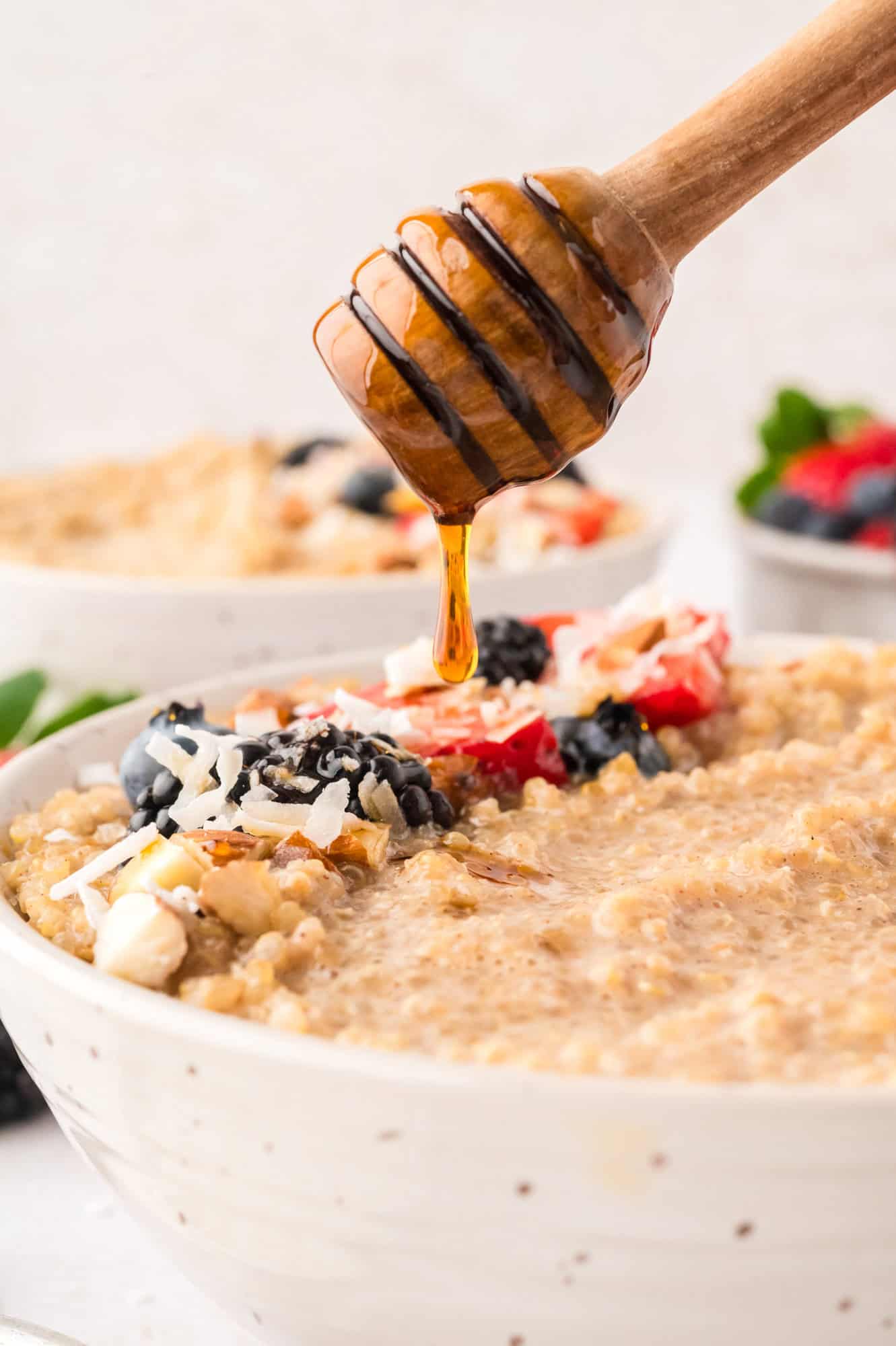 Honey being drizzled on breakfast quinoa.